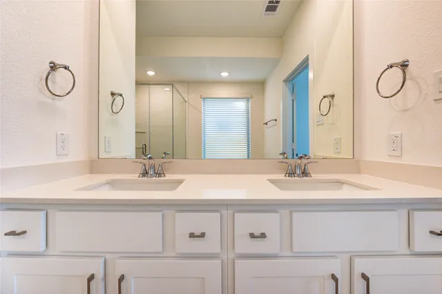 a bathroom with a granite countertop sink mirror and double