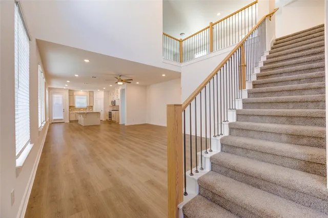 a view of entryway and hall with wooden floor