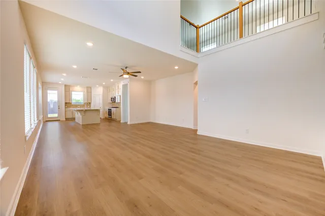 a view of a hallway with wooden floor and a large window