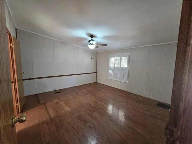 wooden floor in an empty room with a window