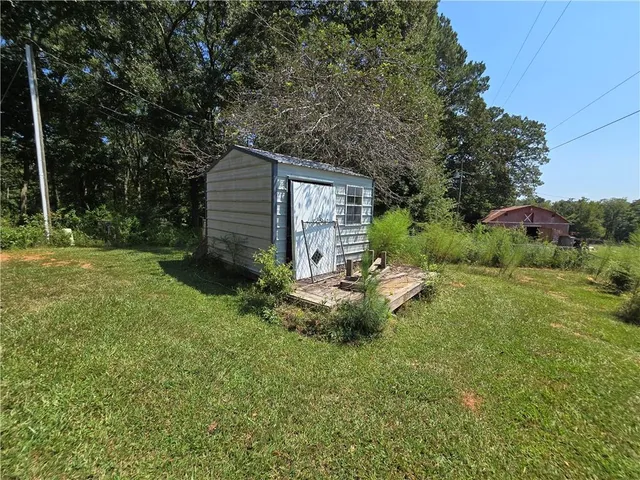 a view of a house with a yard and sitting area