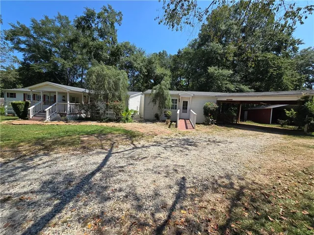 a backyard of a house with swimming pool and trees