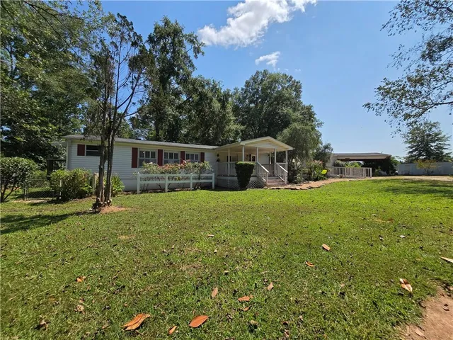 a view of a house with a yard patio and swimming pool