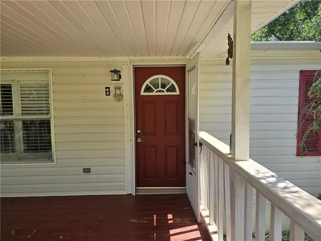 a view of a door and wooden floor