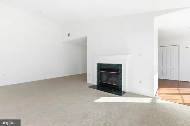 a view of empty room with a fireplace