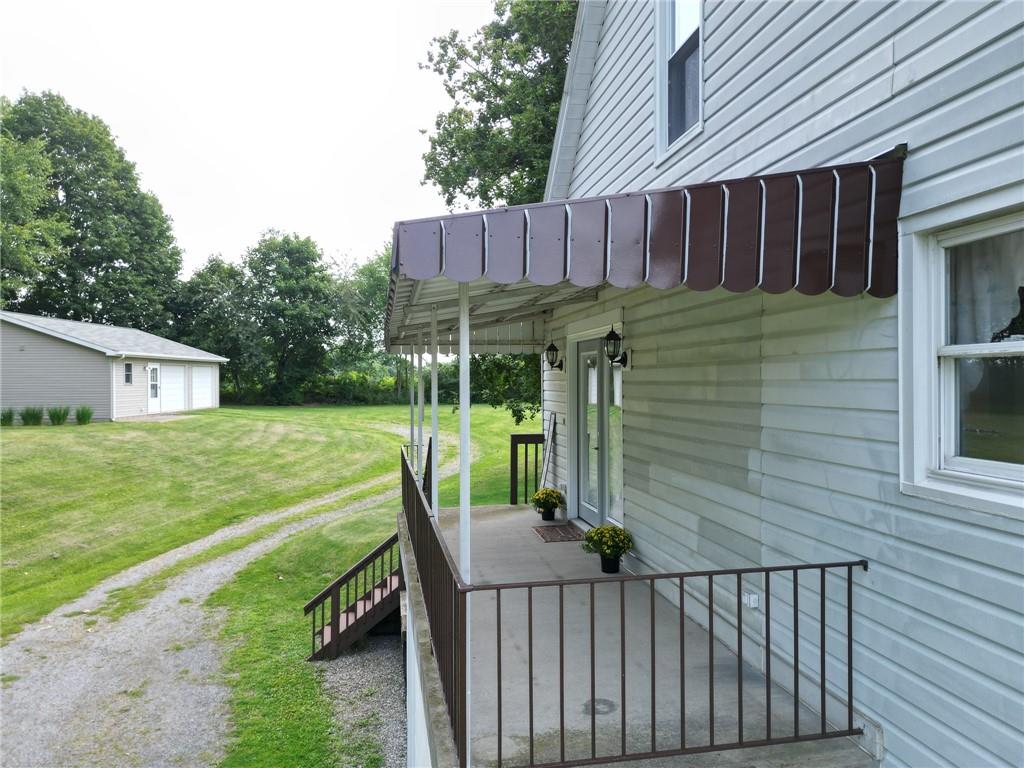 393 Freeport Road Butler, PA 16002 - Photo 36 of 43 a view of a deck with a chair under an umbrella