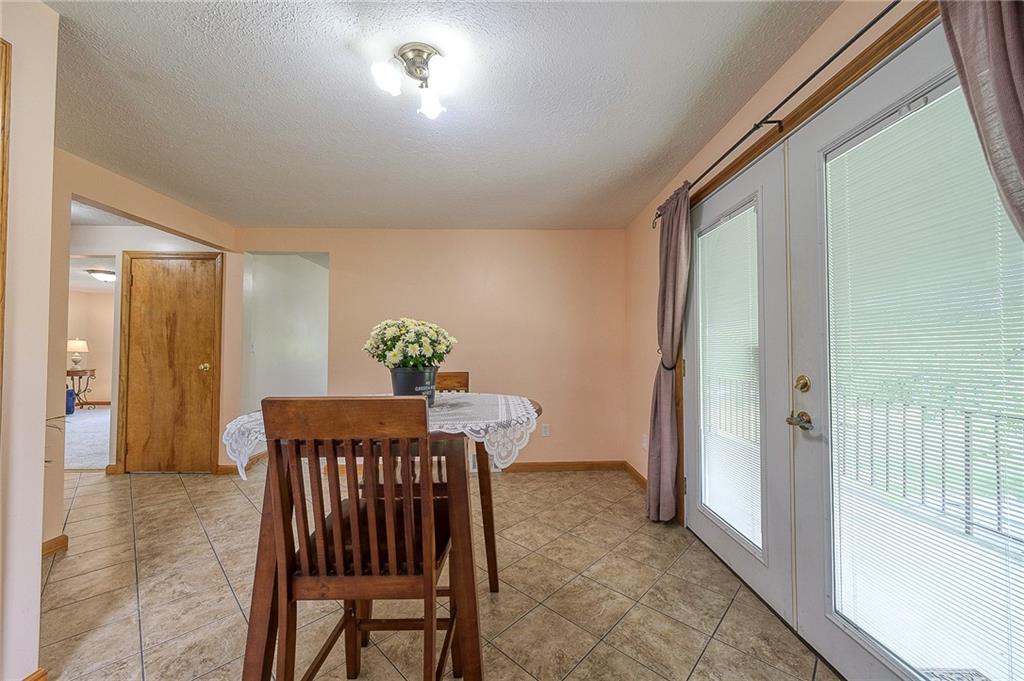 393 Freeport Road Butler, PA 16002 - Photo 8 of 43 a view of a dining room with furniture and wooden floor