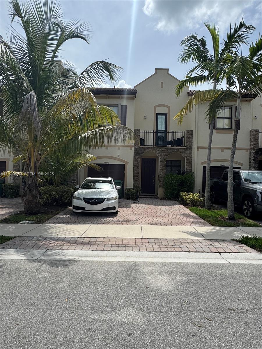 a car parked in front of house with a yard