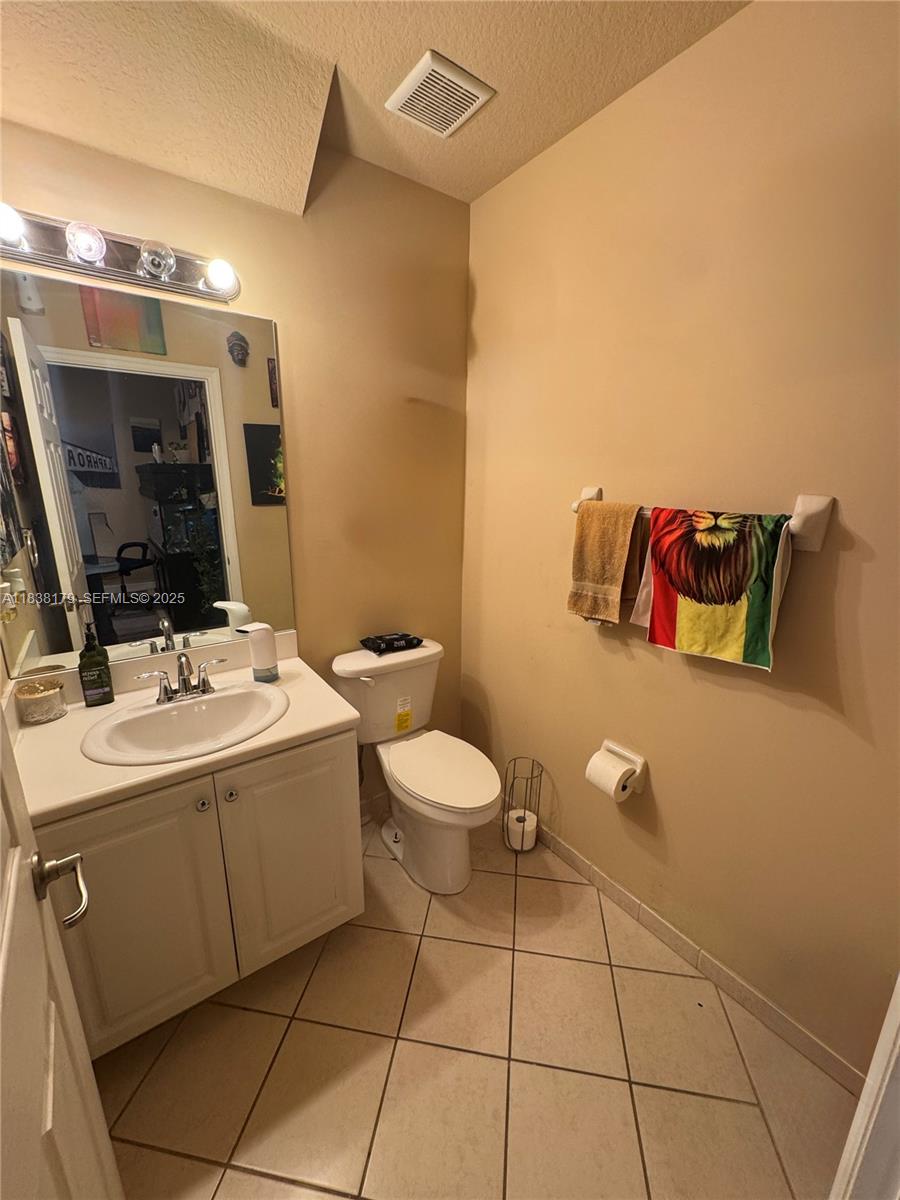 23477 Southwest 112th Place Homestead, FL 33032 - Photo 11 of 49 a bathroom with a toilet sink and mirror