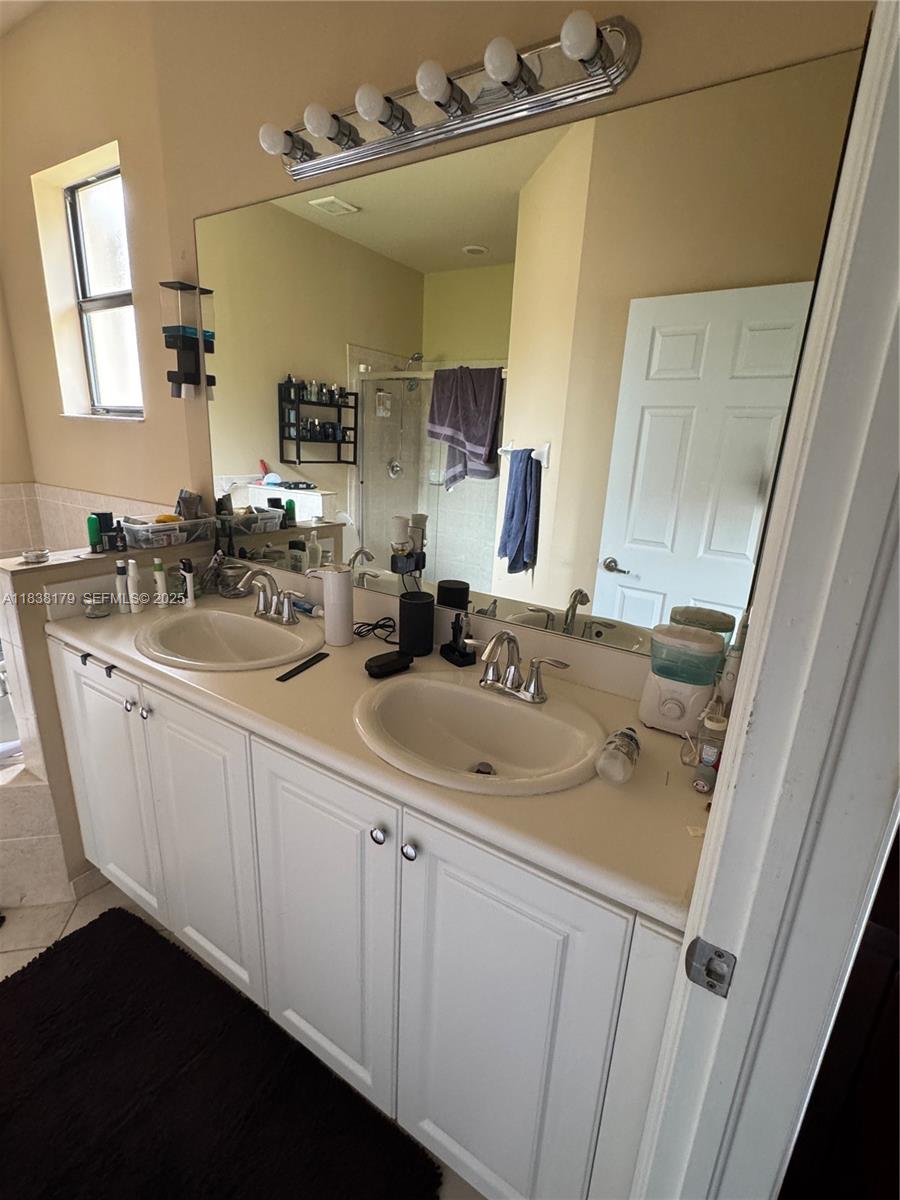 23477 Southwest 112th Place Homestead, FL 33032 - Photo 19 of 49 a bathroom with a sink vanity granite and a mirror