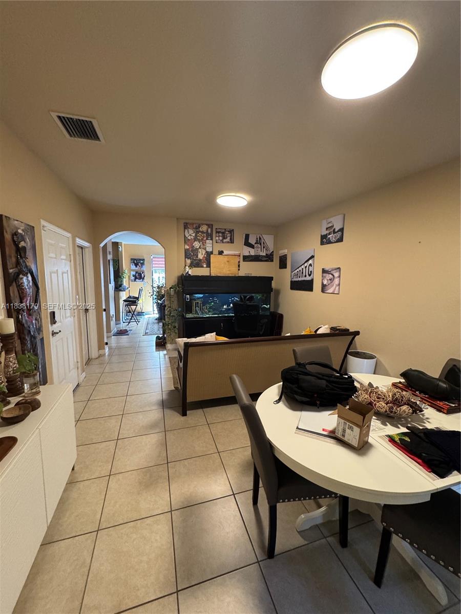 23477 Southwest 112th Place Homestead, FL 33032 - Photo 2 of 49 a kitchen with a table and chairs in it