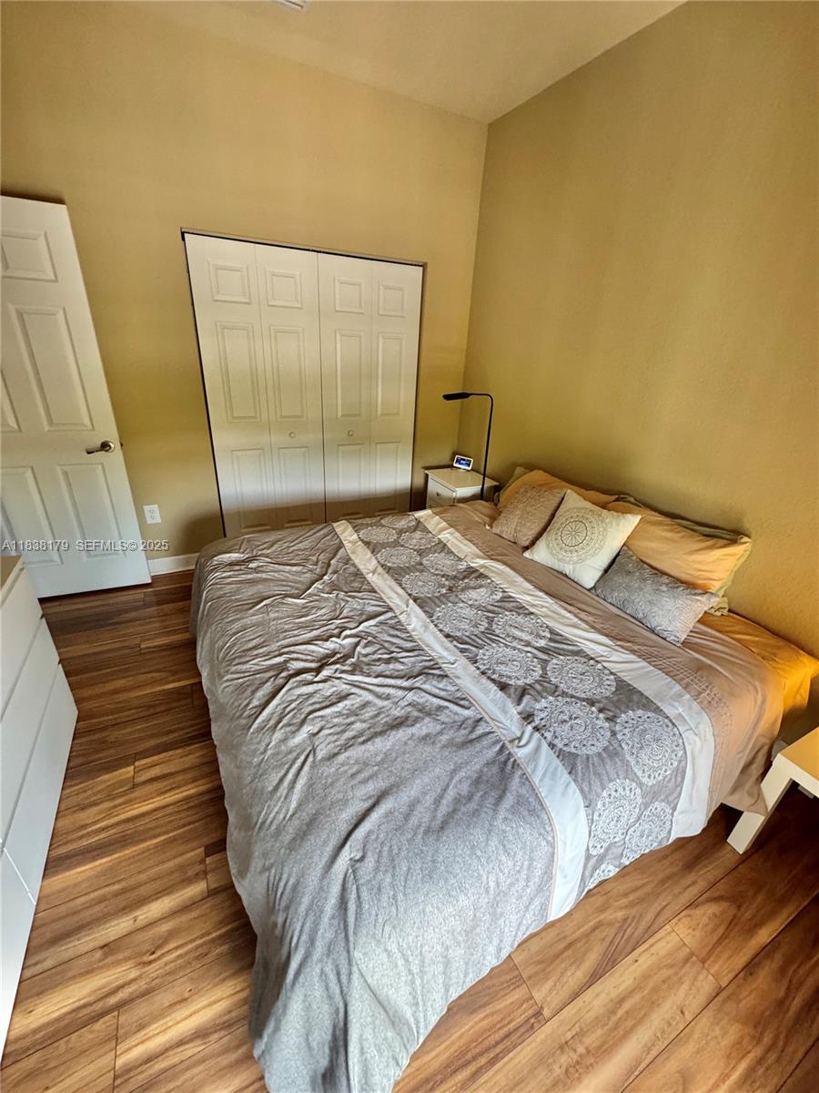 23477 Southwest 112th Place Homestead, FL 33032 - Photo 22 of 49 a bed sitting in a bedroom next to a window