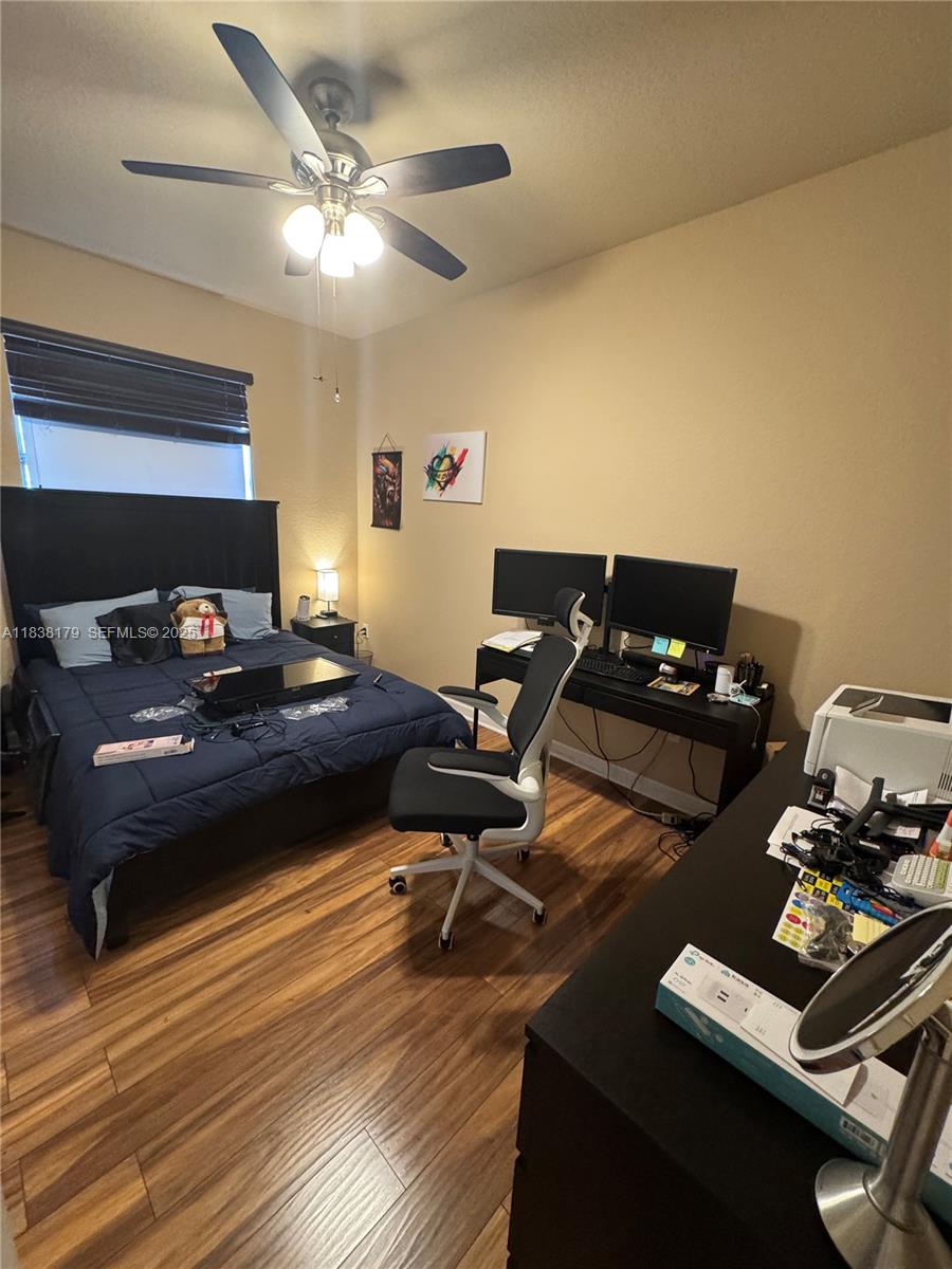 23477 Southwest 112th Place Homestead, FL 33032 - Photo 25 of 49 a living room with furniture and a wooden floor