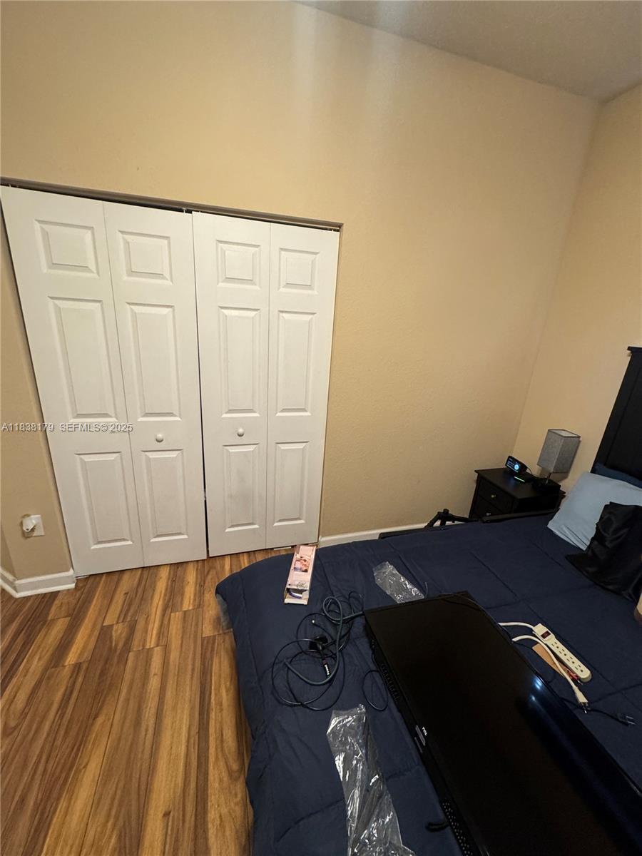 23477 Southwest 112th Place Homestead, FL 33032 - Photo 26 of 49 a bed sitting in a bedroom next to a window