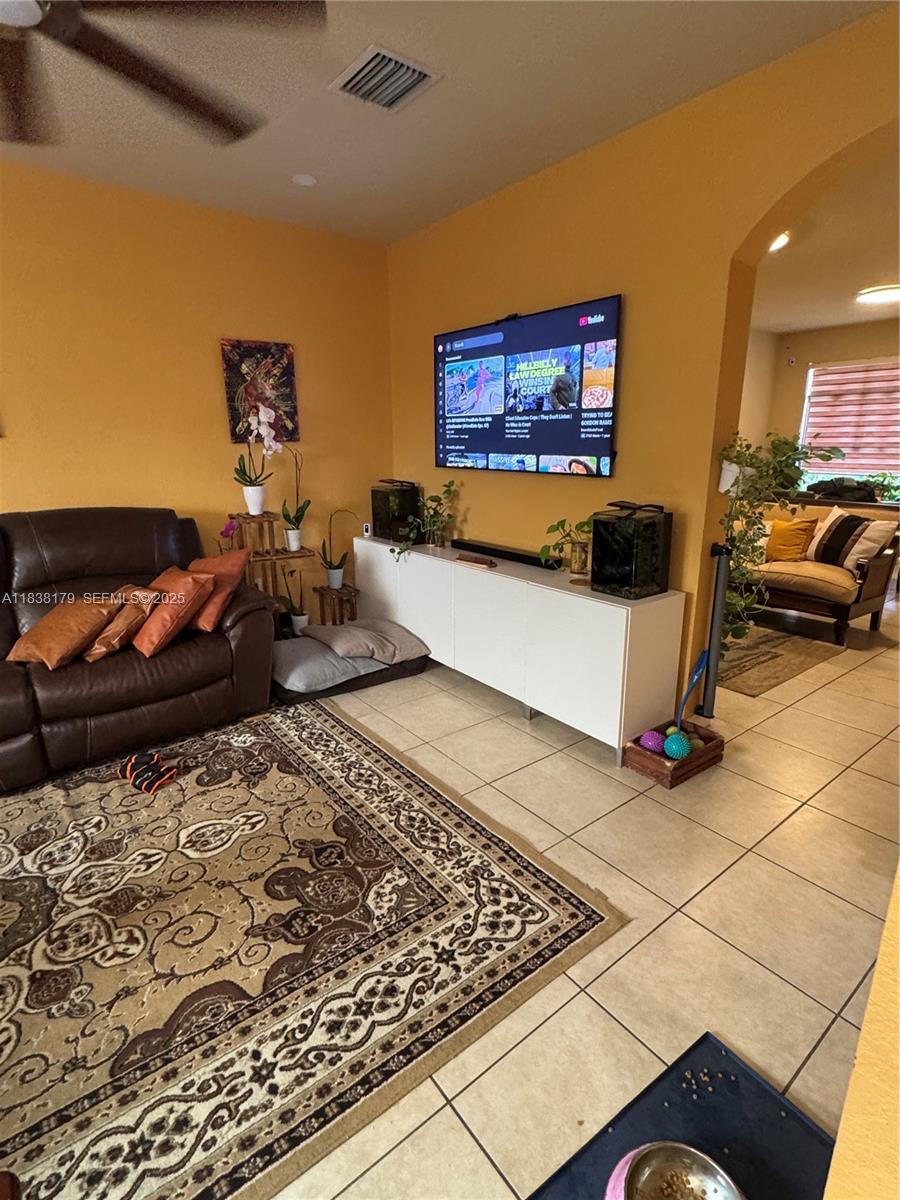 23477 Southwest 112th Place Homestead, FL 33032 - Photo 4 of 49 a living room with furniture and a flat screen tv