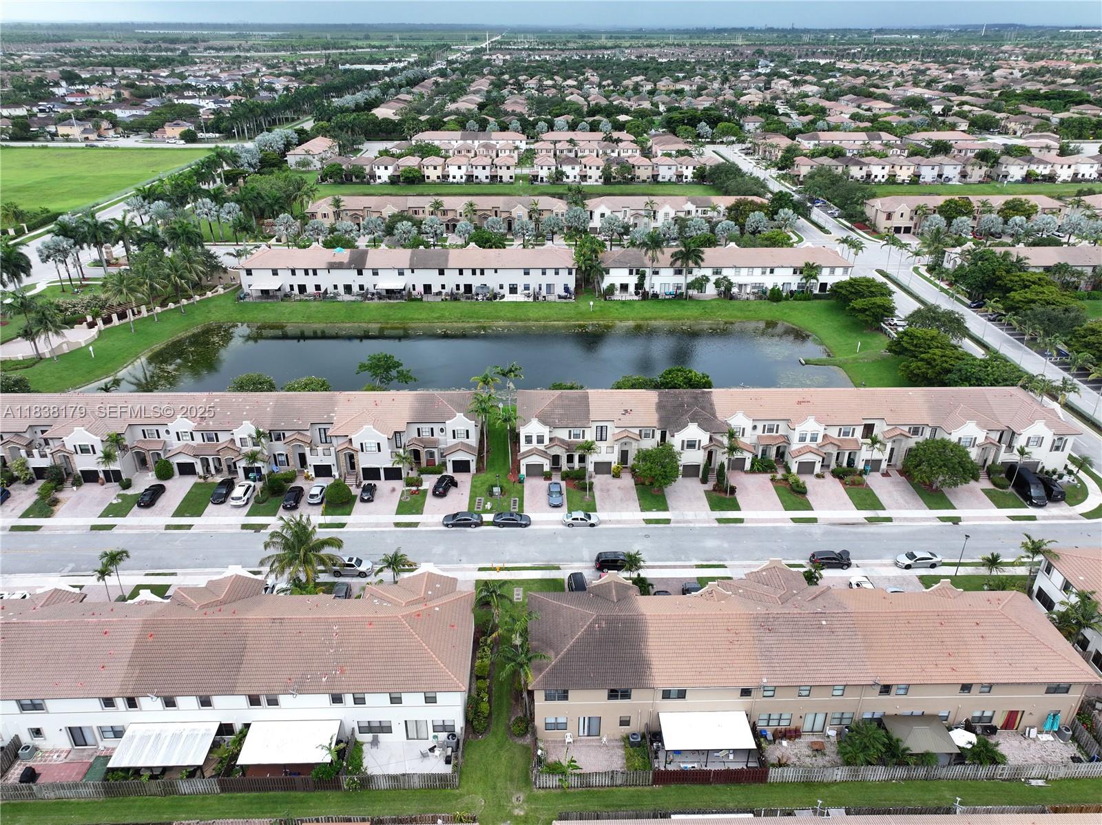 23477 Southwest 112th Place Homestead, FL 33032 - Photo 47 of 49 an aerial view of a house with yard lake and ocean view