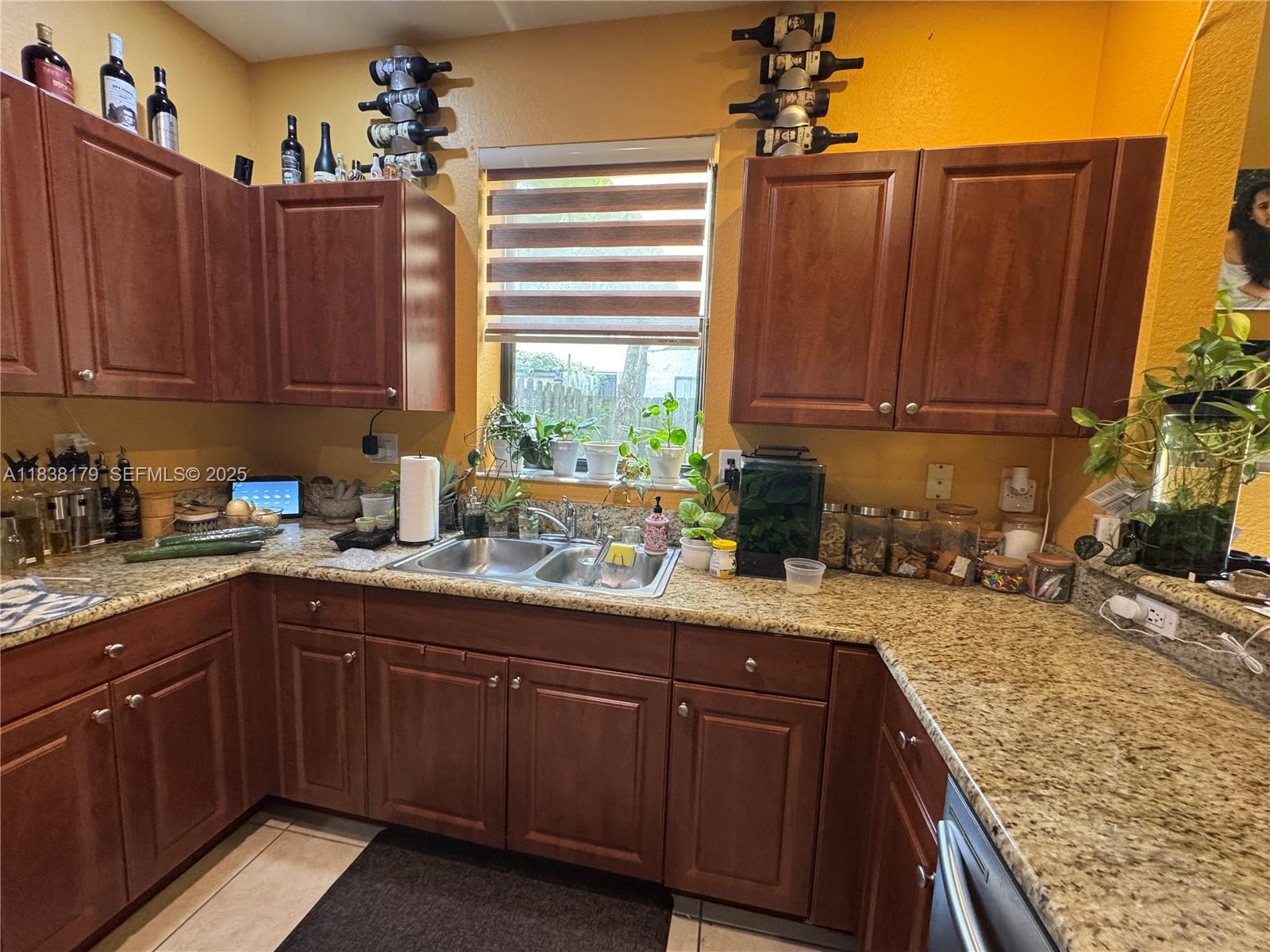 23477 Southwest 112th Place Homestead, FL 33032 - Photo 8 of 49 a kitchen with a sink and cabinets