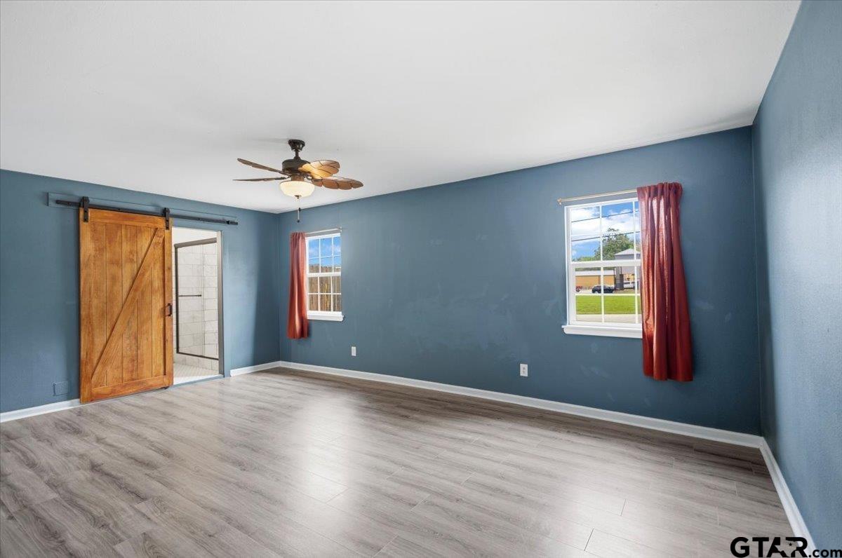 701 Georgia Street Lindale, TX 75771 - Photo 13 of 37 a view of a livingroom with a window and wooden floor