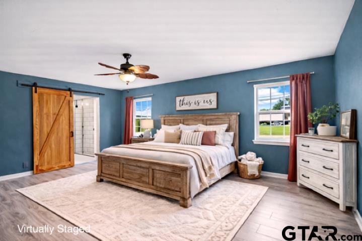 701 Georgia Street Lindale, TX 75771 - Photo 14 of 37 a spacious bedroom with a large bed and a window