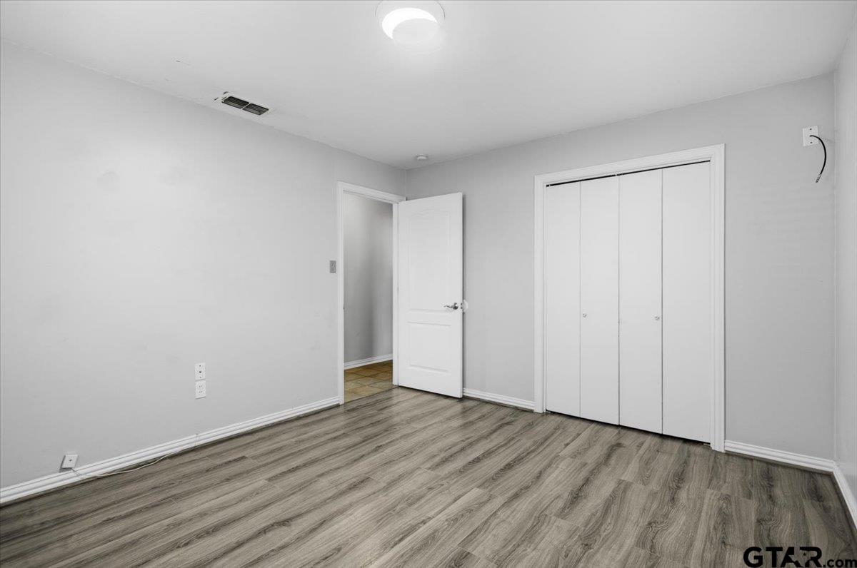 701 Georgia Street Lindale, TX 75771 - Photo 23 of 37 a view of an empty room with wooden floor