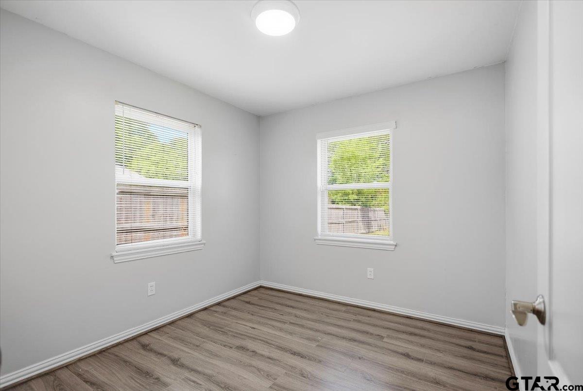 701 Georgia Street Lindale, TX 75771 - Photo 25 of 37 a view of an empty room with wooden floor and a window