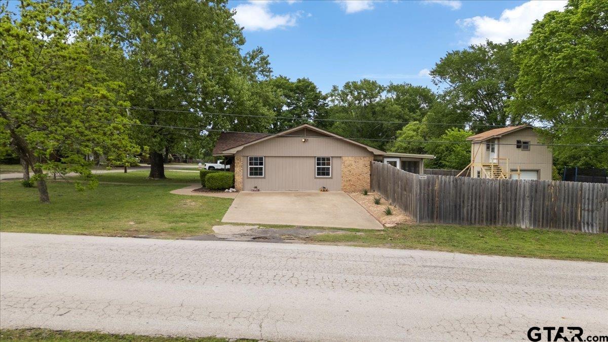 701 Georgia Street Lindale, TX 75771 - Photo 30 of 37 a front view of house with a yard and trees