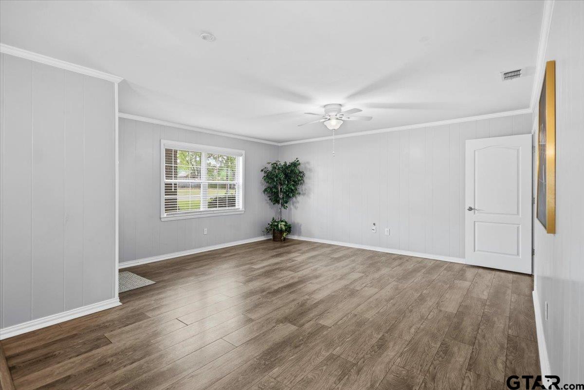 701 Georgia Street Lindale, TX 75771 - Photo 5 of 37 an empty room with wooden floor and windows