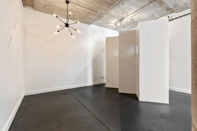 a view of a room with wooden floor