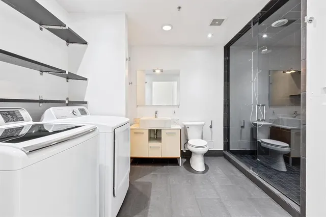 a bathroom with a toilet a sink and mirror