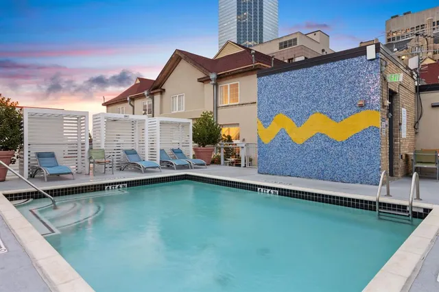 a swimming pool with outdoor seating and yard