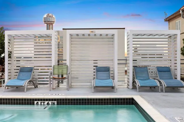 a view of a swimming pool with outdoor seating