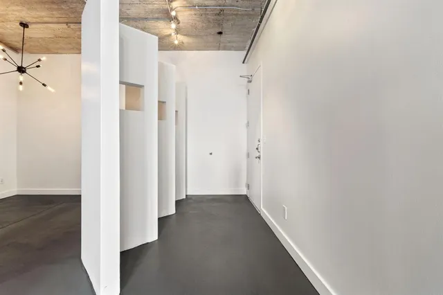 a view of a hallway with a wooden floor