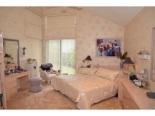 17064 Ryton Lane Boca Raton, FL 33496 - Photo 13 of 23 a bedroom with a bed and a large mirror