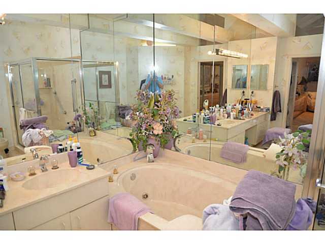 17064 Ryton Lane Boca Raton, FL 33496 - Photo 14 of 23 a bathroom with a double vanity sink and a mirror