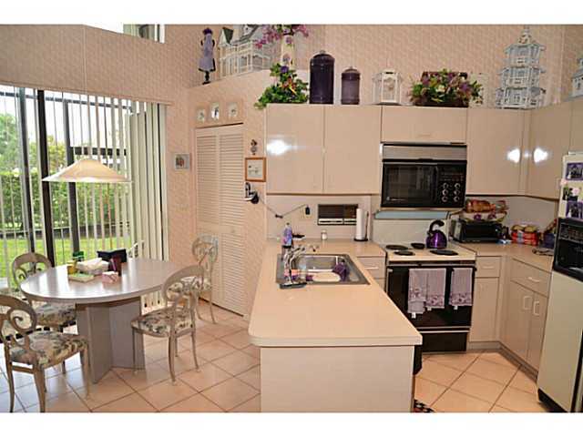 17064 Ryton Lane Boca Raton, FL 33496 - Photo 10 of 23 a kitchen with a sink a stove and a refrigerator