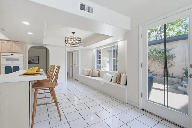 a kitchen with white cabinets and a sink