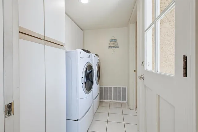 a bedroom with bed couches and chandelier