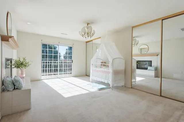 a bedroom with a large bed and a chandelier