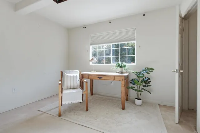 a view of a patio with a table and chairs under an umbrella with plants