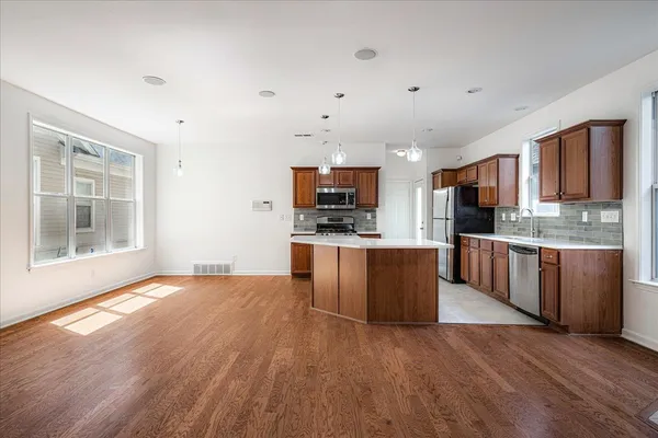 a kitchen with stainless steel appliances granite countertop a sink stove and cabinets