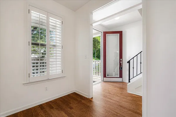 a view of an entryway with wooden floor and windows