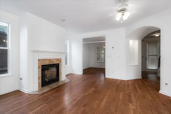 a large kitchen with stainless steel appliances granite countertop a large stove a sink dishwasher and a microwave oven on the wooden floor