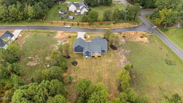 an aerial view of a house with a yard lake view and mountain view