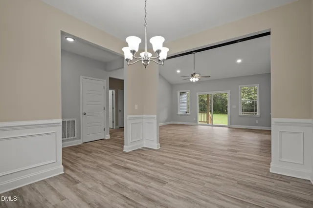 a view of a livingroom with a ceiling fan window and wooden floor