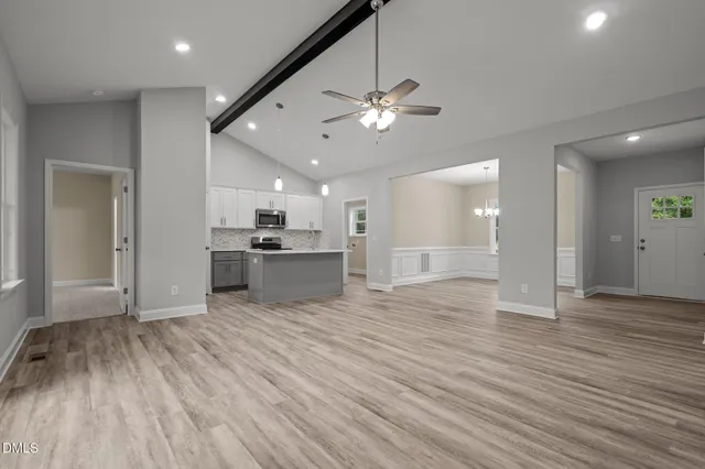 a living room with furniture ceiling fan and a window