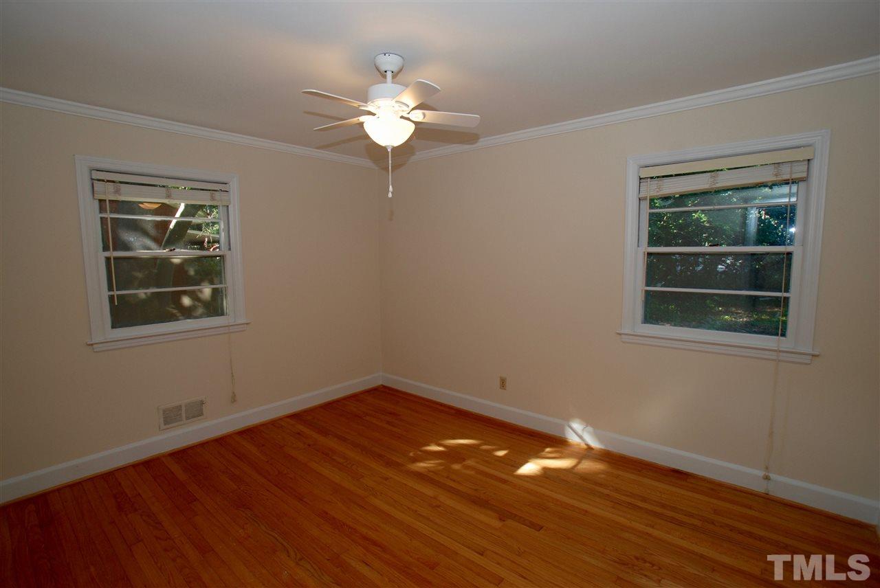 3404 Cherry Lane Raleigh, NC 27607 - Photo 12 of 19 a view of wooden floor and chandelier fan in a room