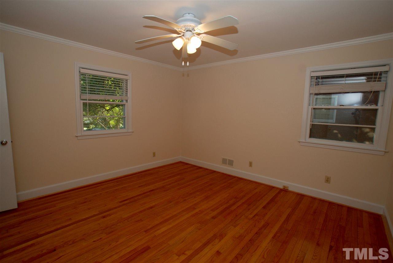 3404 Cherry Lane Raleigh, NC 27607 - Photo 13 of 19 a view of an empty room with a window and wooden floor