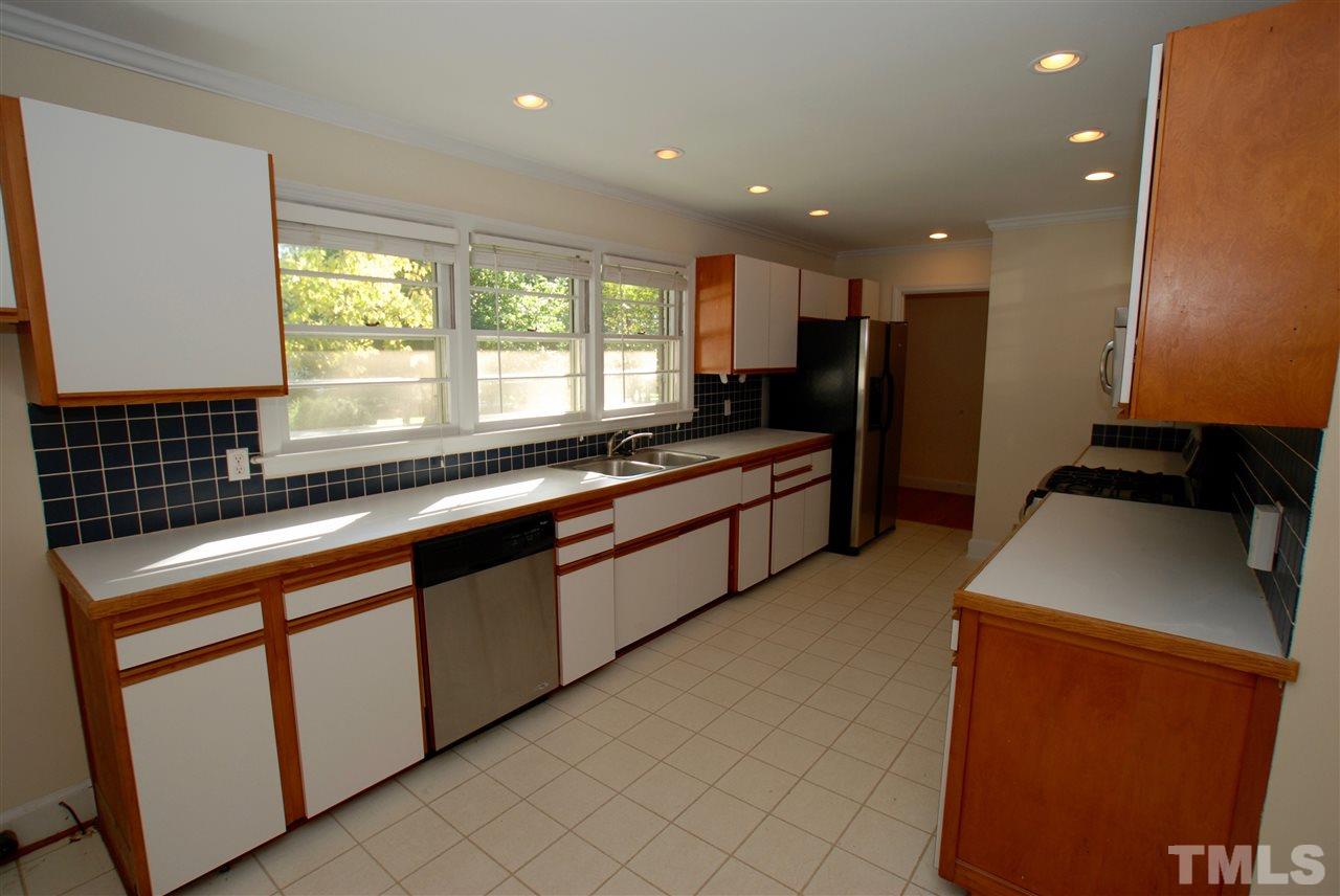 3404 Cherry Lane Raleigh, NC 27607 - Photo 3 of 19 a large kitchen with stainless steel appliances granite countertop a sink and a stove top oven