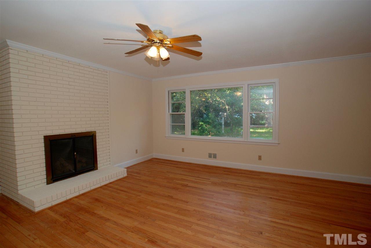 3404 Cherry Lane Raleigh, NC 27607 - Photo 7 of 19 a view of an empty room with a fireplace and a window