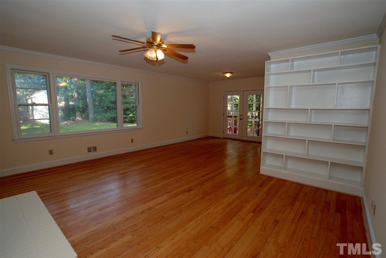 3404 Cherry Lane Raleigh, NC 27607 - Photo 8 of 19 a view of an empty room with a window and wooden floor